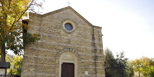 Façade of the Church of Santa Maria Assunta with trees